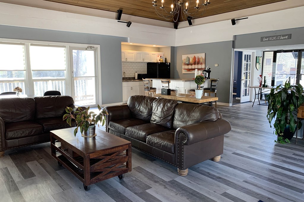 a living room with leather couches and a coffee table at Timber Ridge Apartments, Cincinnati