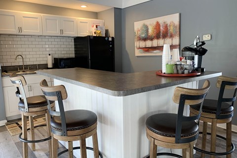 a kitchen with a counter top and three bar stools