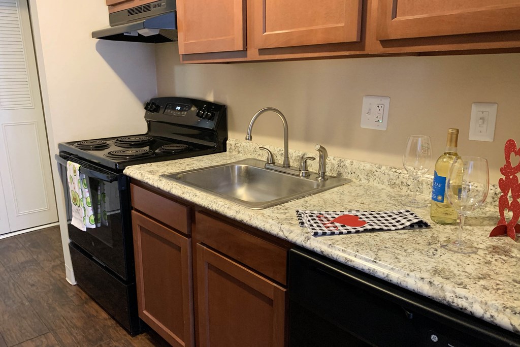 a kitchen with a sink and a stove and a counter top  at Timber Ridge Apartments, Ohio, 45241