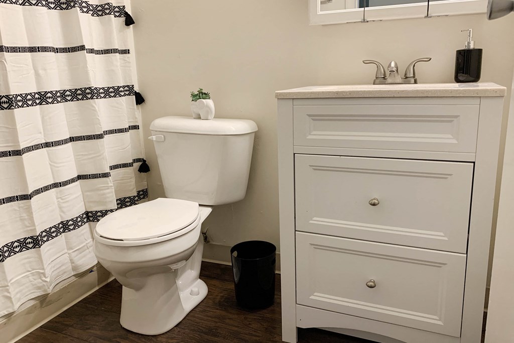 a bathroom with a toilet and a sink  at Timber Ridge Apartments, Cincinnati, Ohio