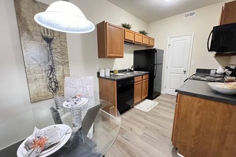 an open kitchen and dining room with a glass table and chairs