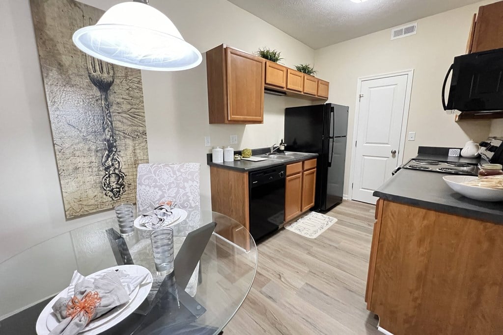 kitchen an open kitchen and dining room with a glass table and chairs at Residences at Northgate Crossing, Ohio, 43235