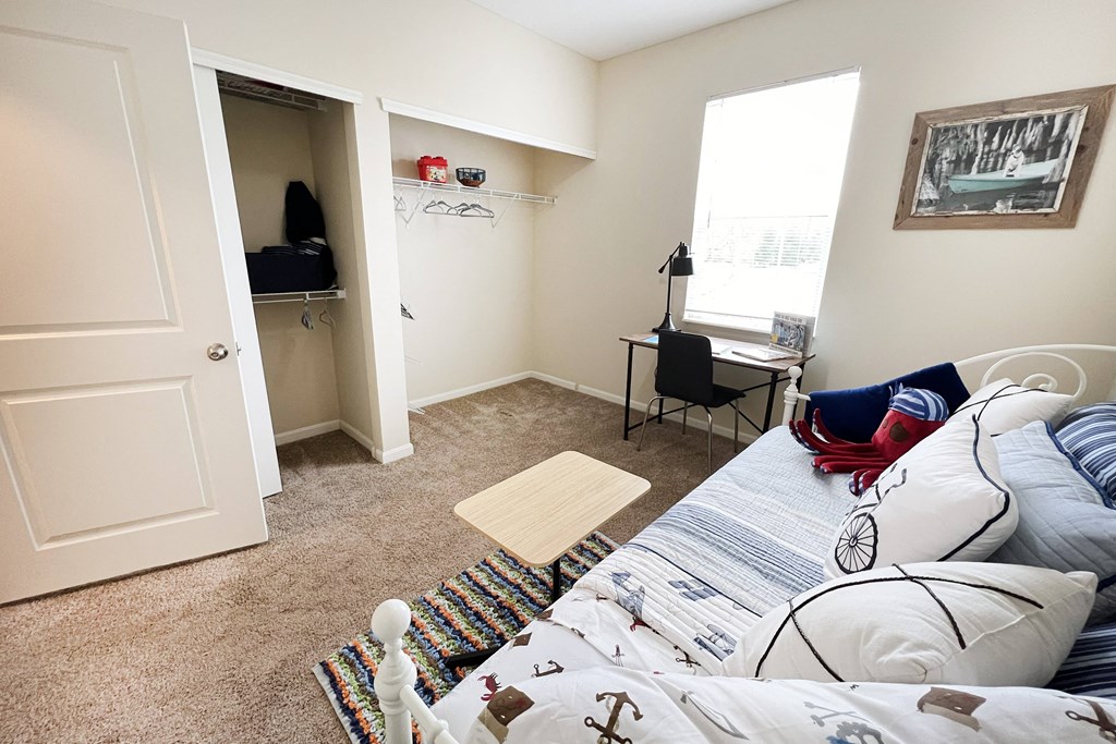a living room with a bed and a closet at Residences at Northgate Crossing, Ohio, 43235