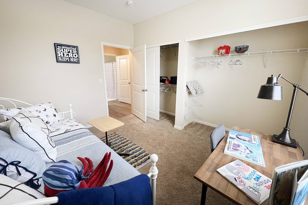 a living room with a couch and a desk and a closet at Residences at Northgate Crossing, Ohio, 43235