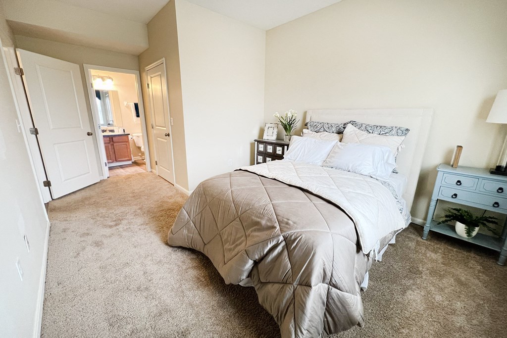 an empty bedroom with a bed and a bathroom at Residences at Northgate Crossing, Ohio, 43235