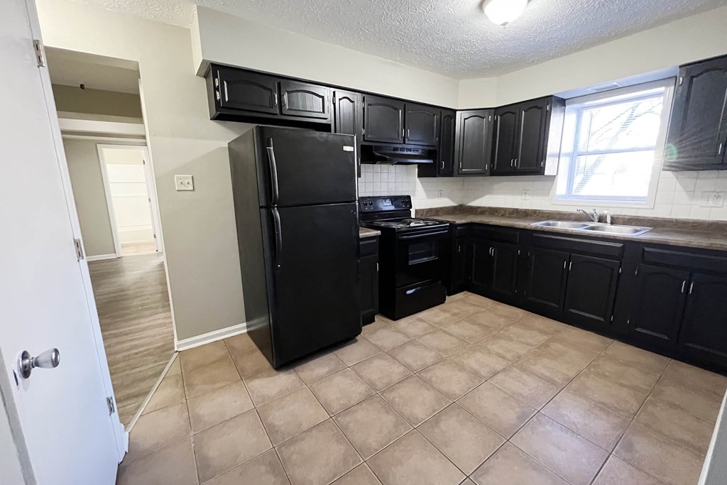 Kitchen with black appliances and cabinets at Park Place, Richmond, KY