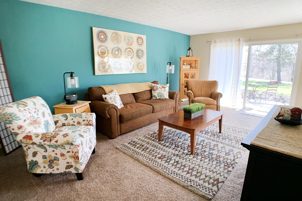 a living room with a couch and a chair and a table at Timber Ridge Apartments, Cincinnati