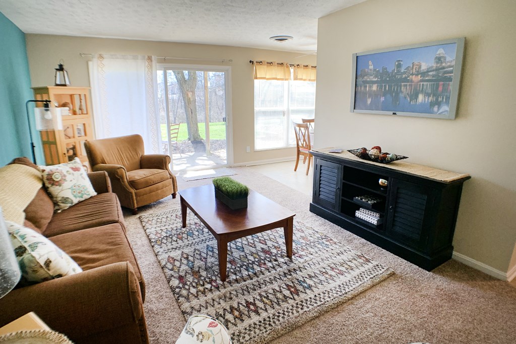 a living room with a couch and a table and a fireplace at Timber Ridge Apartments, Cincinnati, Ohio