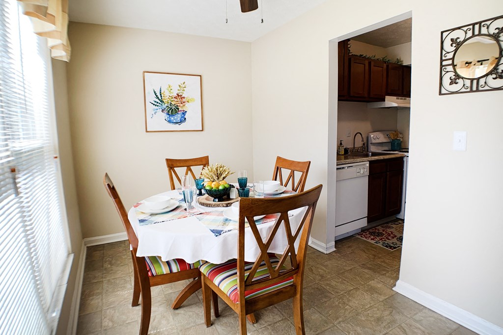 a dining room with a table and chairs and a kitchen at Timber Ridge Apartments, Cincinnati, OH, 45241