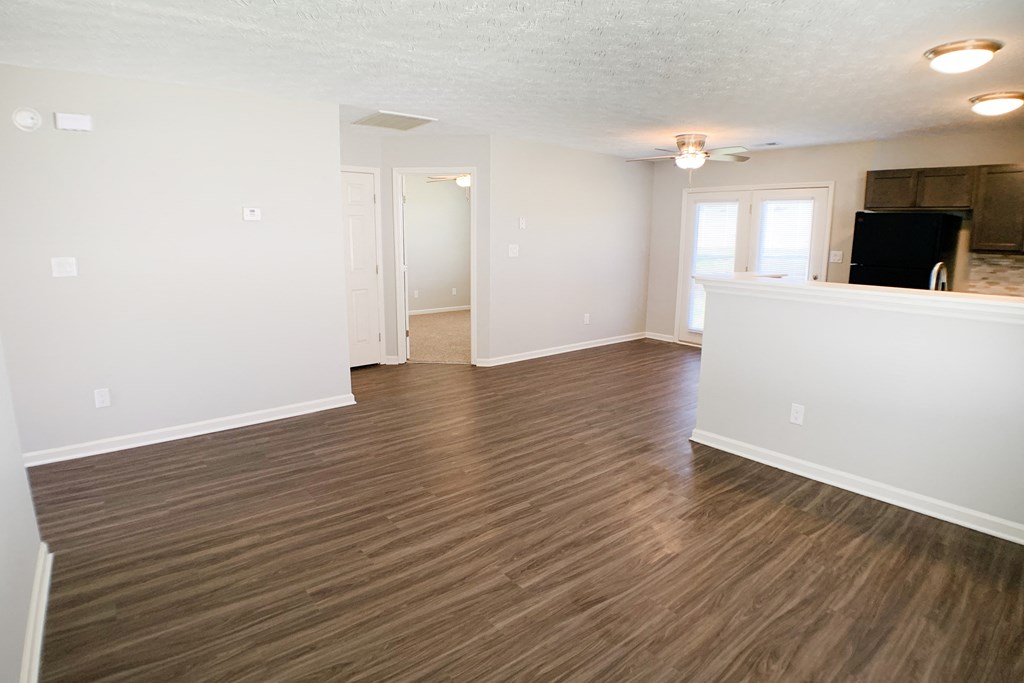 an empty living room with wood flooring in an apartment  at Aberdine Place, Georgetown