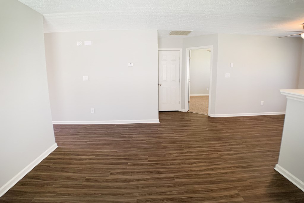an empty living room with wood flooring and white walls  at Aberdine Place, Kentucky