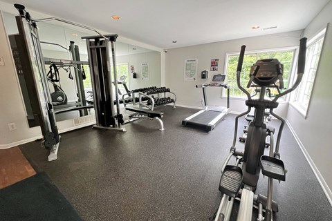 a gym with exercise equipment on the floor and a window at The Vinings Apartments, Cincinnati, Ohio