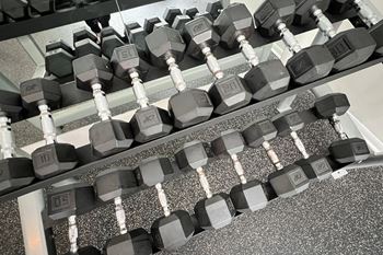 a row of dumbbells on the floor of a gym at The Vinings Apartments, Cincinnati, Ohio