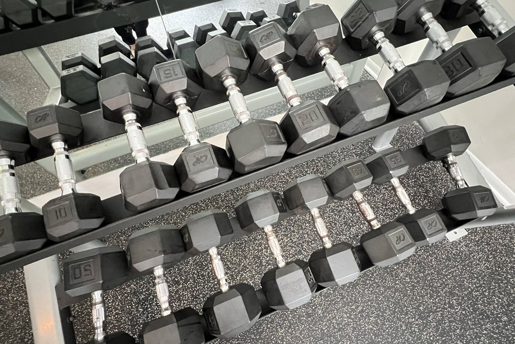 a row of dumbbells on the floor of a gym at The Vinings Apartments, Cincinnati, 45245