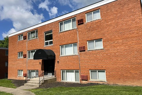 a brick building with an awning on the side of it at Crown Court Apartments, Kentucky, 41042