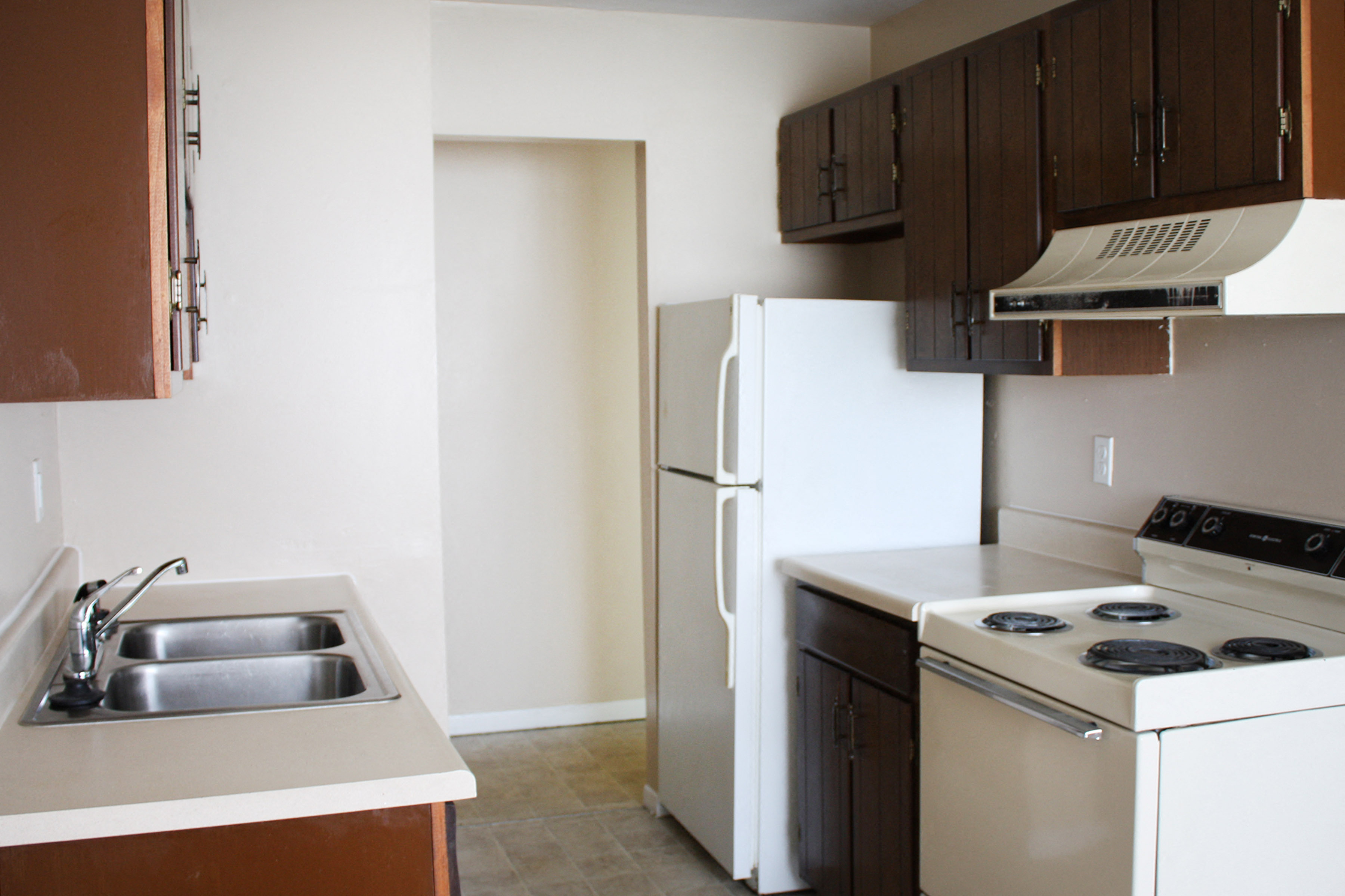 Kitchen with white appliances at Sharondale Woods Apartments, Cincinnati