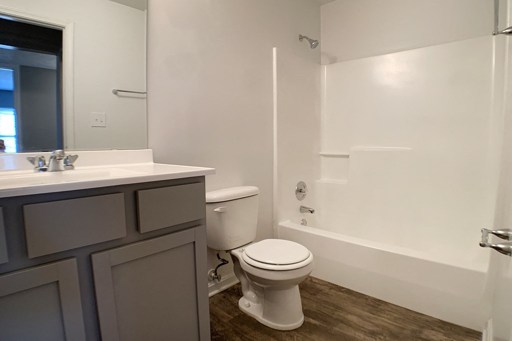an empty bathroom with a toilet and a sink at Knobs Pointe Apartments, New Albany