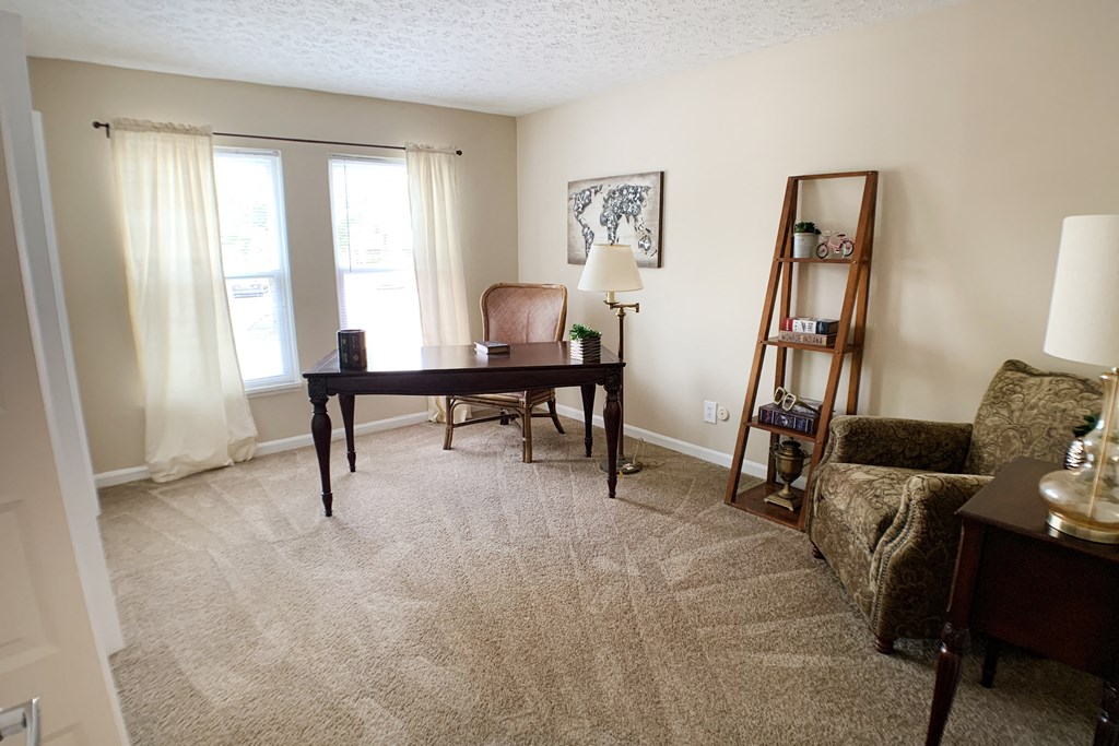 a living room with a desk and a couch  at Knobs Pointe Apartments, New Albany, IN, 47150