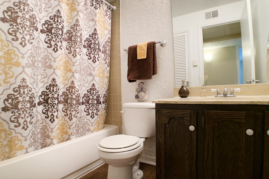a bathroom with a shower and a toilet and a sink  at Knobs Pointe Apartments, New Albany, IN