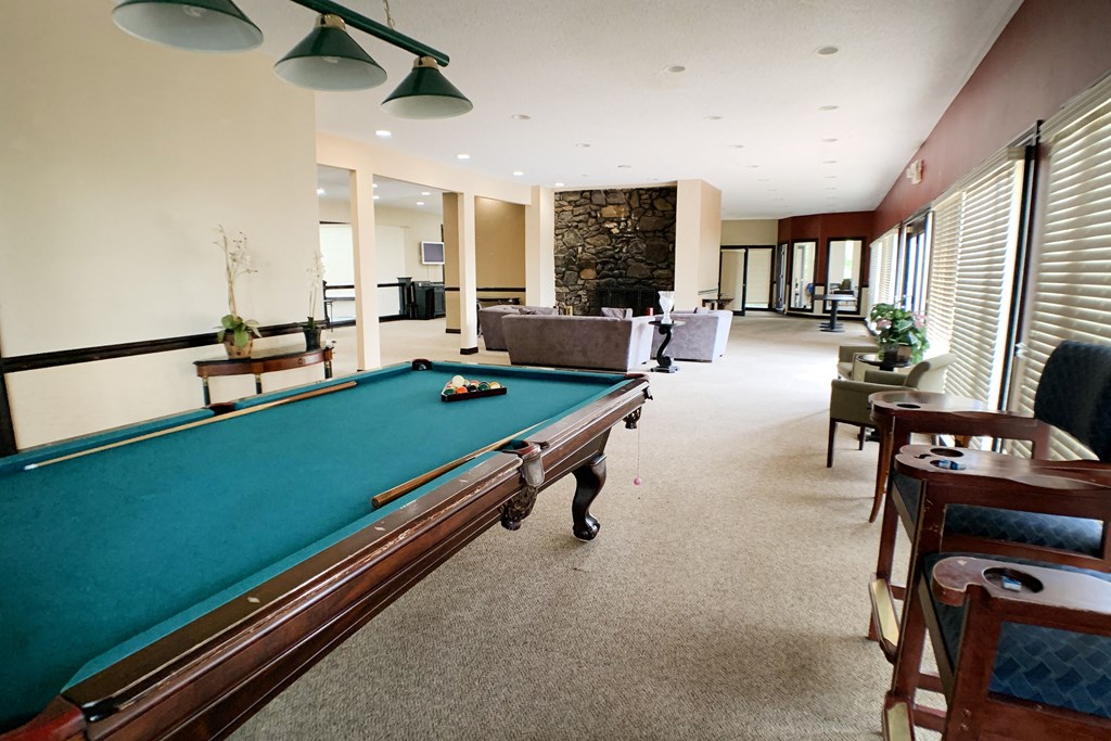 a large living room with a pool table  at Knobs Pointe Apartments, New Albany