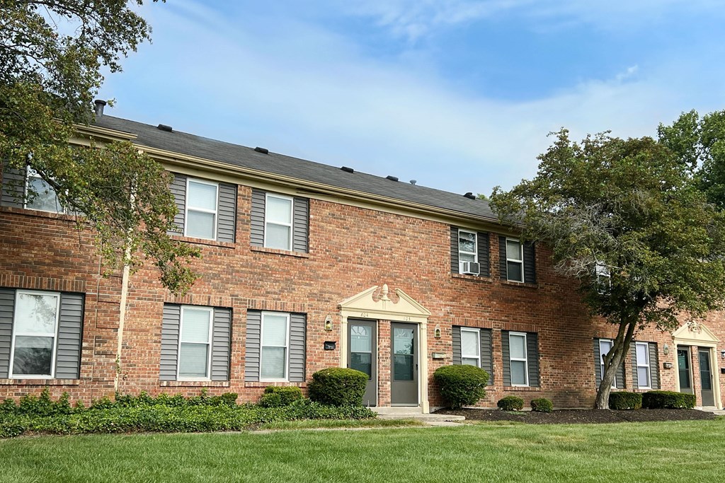 our apartments are located in a brick building with green grass and trees at Revere Village Apartments, Centerville
