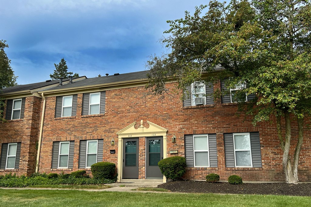 a brick house with a tree in front of it at Revere Village Apartments, Centerville, 45458