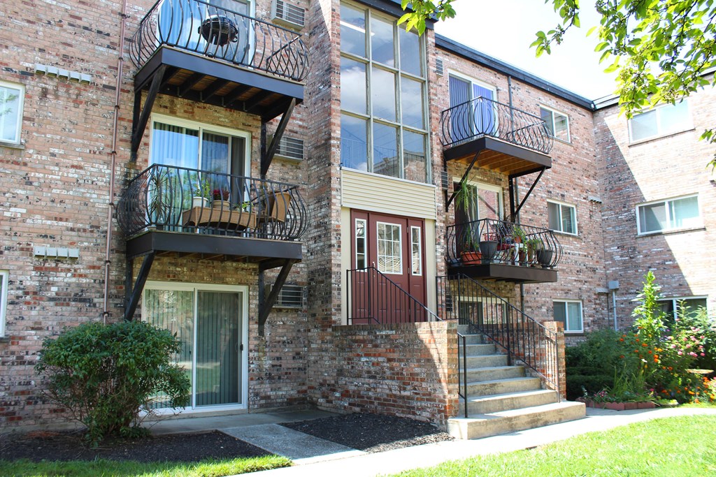 A building with a balcony and a door.
