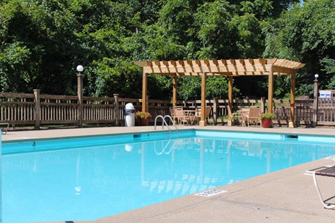 a swimming pool with a wooden canopy next to a resort pool at The Vinings Apartments, Cincinnati, 45245