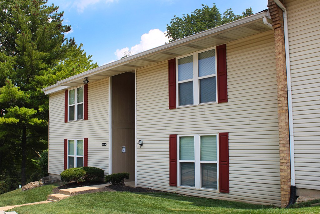 a white house with red shutters and a lawn  at Timber Ridge Apartments, Cincinnati, OH, 45241