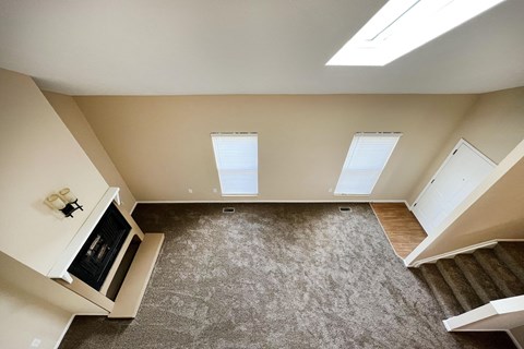 an overhead view of a living room with a carpeted floor and two windows