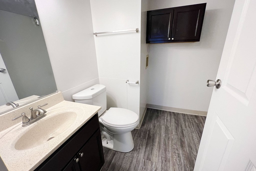 a bathroom with a toilet sink and mirror at Quail Meadow Apartments, Cincinnati, 45240