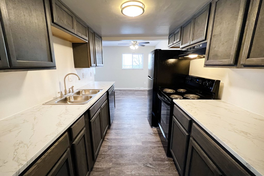 a kitchen with dark cabinets and white countertops at Wentworth Estates Apartments, Florence, KY