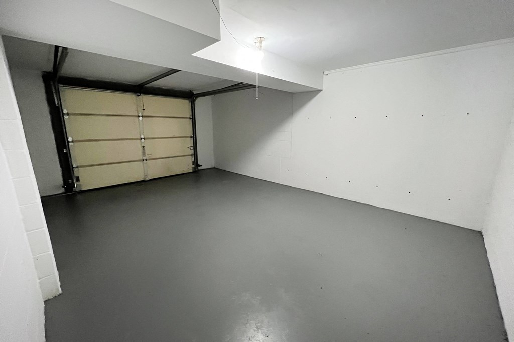 an empty room with a garage door in the corner at Wentworth Estates Apartments, Florence, KY