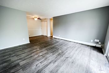 a bedroom with hardwood floors and grey walls