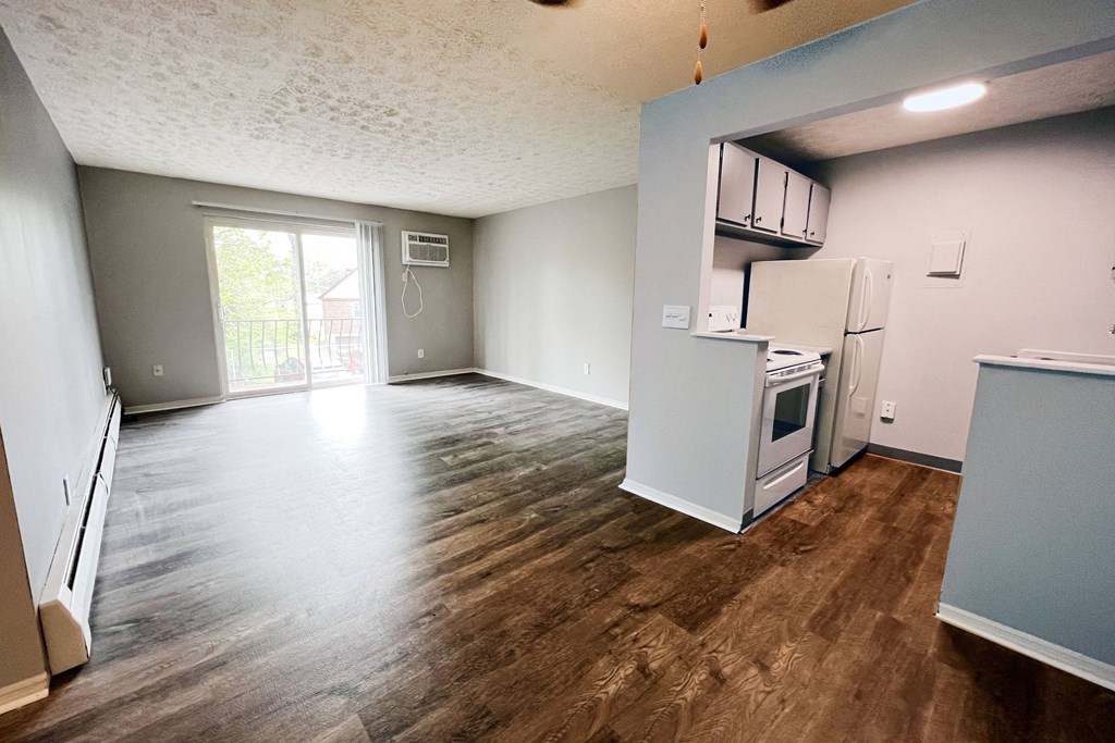 a kitchen and living room in an apartment  at Summit East - A Senior Community, Cincinnati, OH, 45237