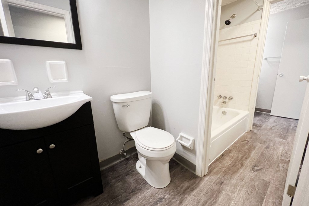 a bathroom with a toilet sink and bathtub  at Summit East - A Senior Community, Ohio, 45237