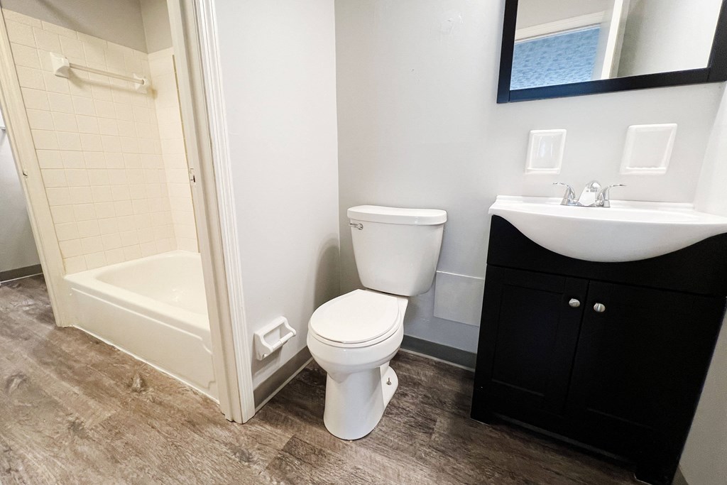 a bathroom with a toilet sink and bathtub  at Summit East - A Senior Community, Cincinnati