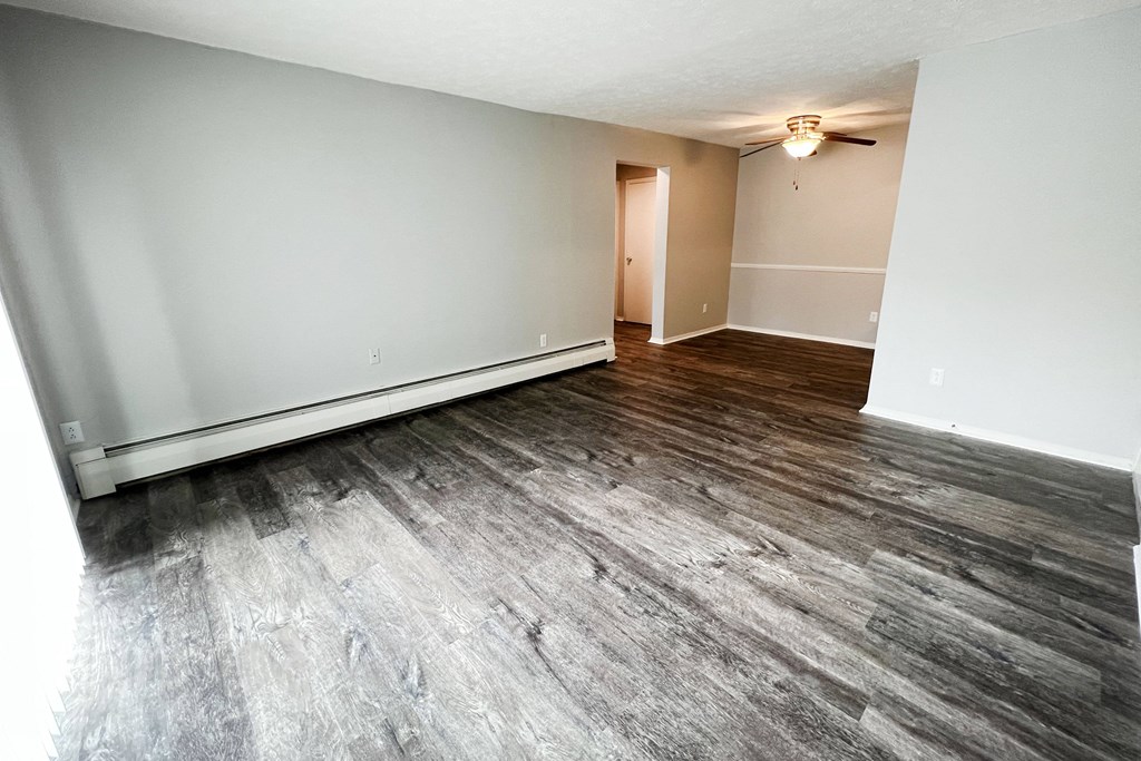 an empty living room with a ceiling fan  at Summit East - A Senior Community, Cincinnati, Ohio
