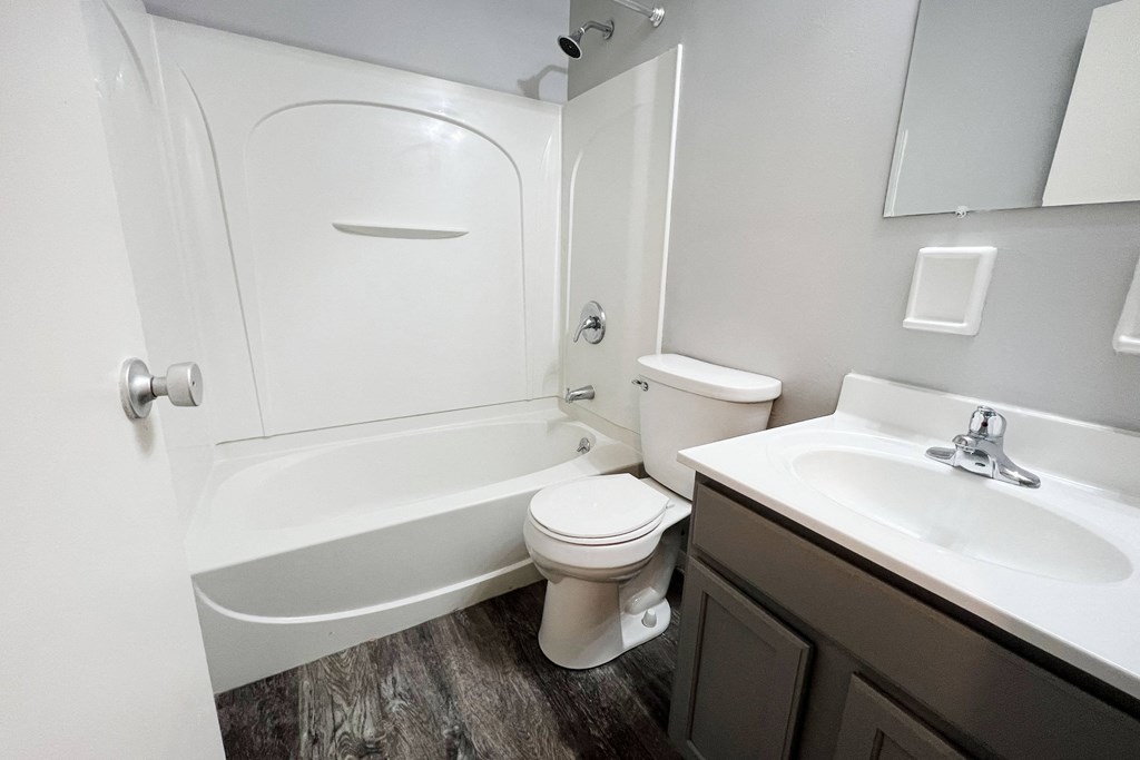 a bathroom with a toilet sink and bathtub  at Summit East - A Senior Community, Ohio, 45237