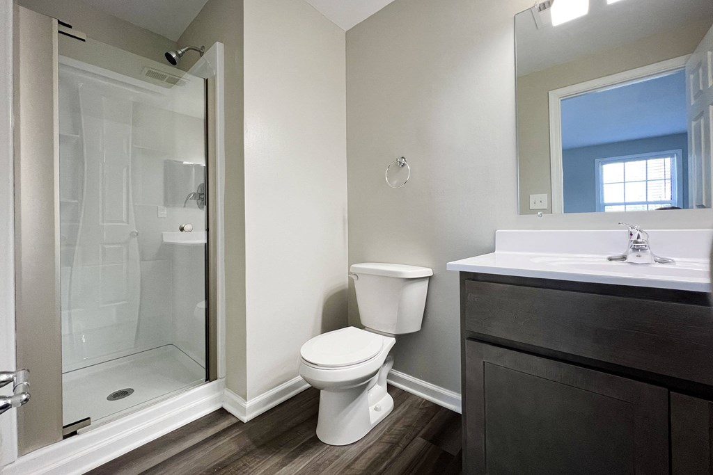 a bathroom with a toilet sink and shower  at Woodhills Apartments, West Carrollton