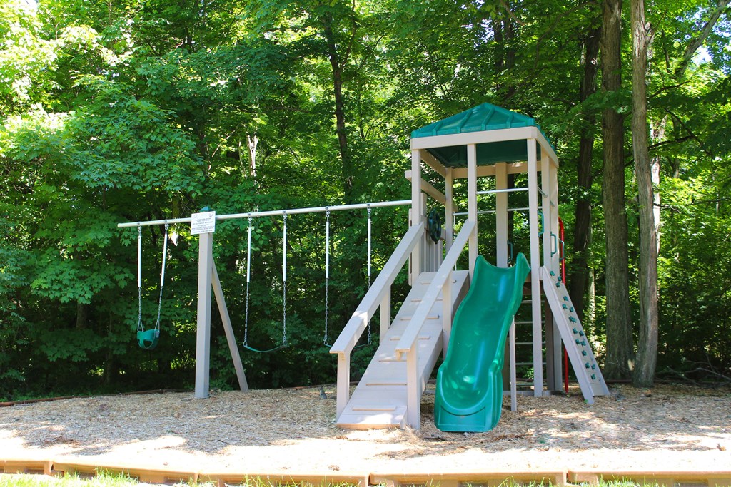 a playground with a slide and a swing set at The Vinings Apartments, Cincinnati, 45245