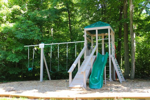 a playground with a slide and a swing set at The Vinings Apartments, Cincinnati, 45245