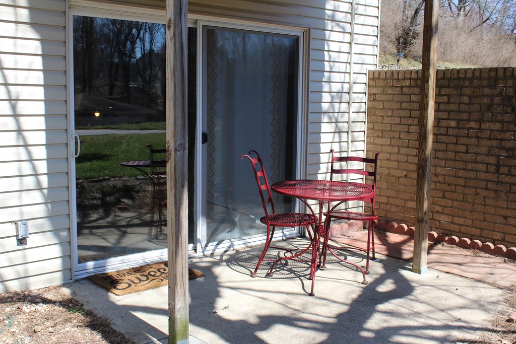 a patio with red chairs and a table on a patio  at Timber Ridge Apartments, Cincinnati, OH, 45241