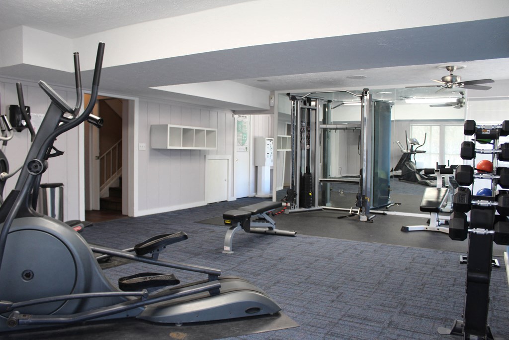 a gym with weights and cardio equipment in a home gym  at Timber Ridge Apartments, Cincinnati, Ohio