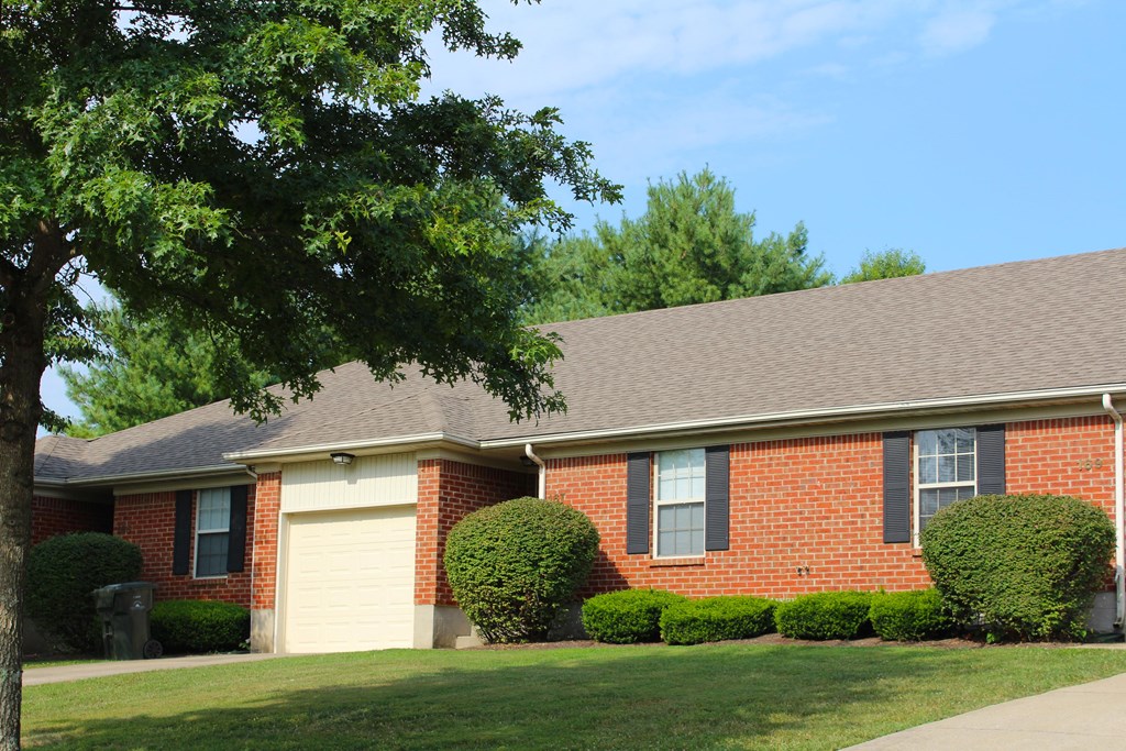 a brick house with a tree in front of it  at Aberdine Place, Georgetown, KY