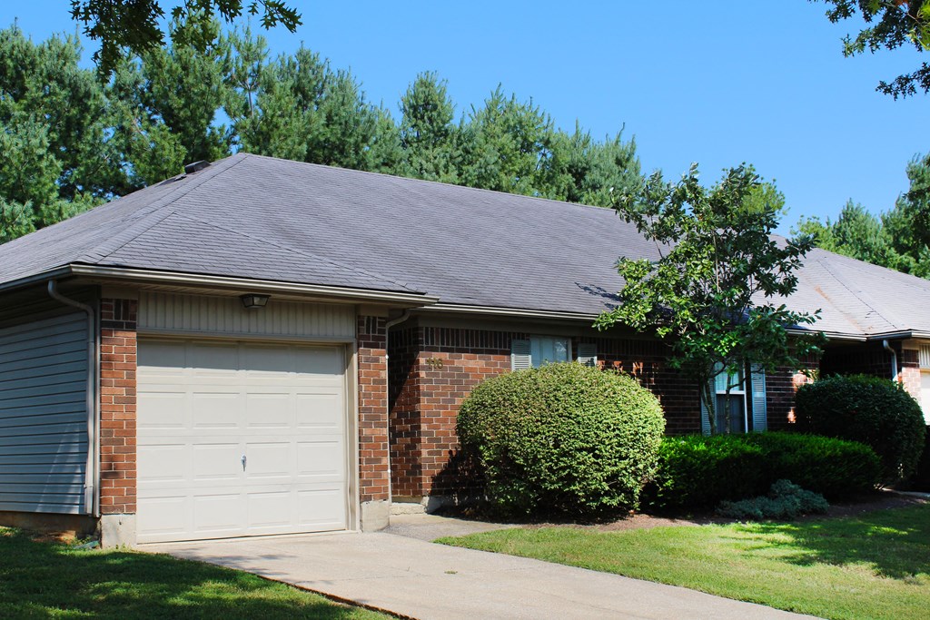 a brick house with a white garage door  at Aberdine Place, Georgetown