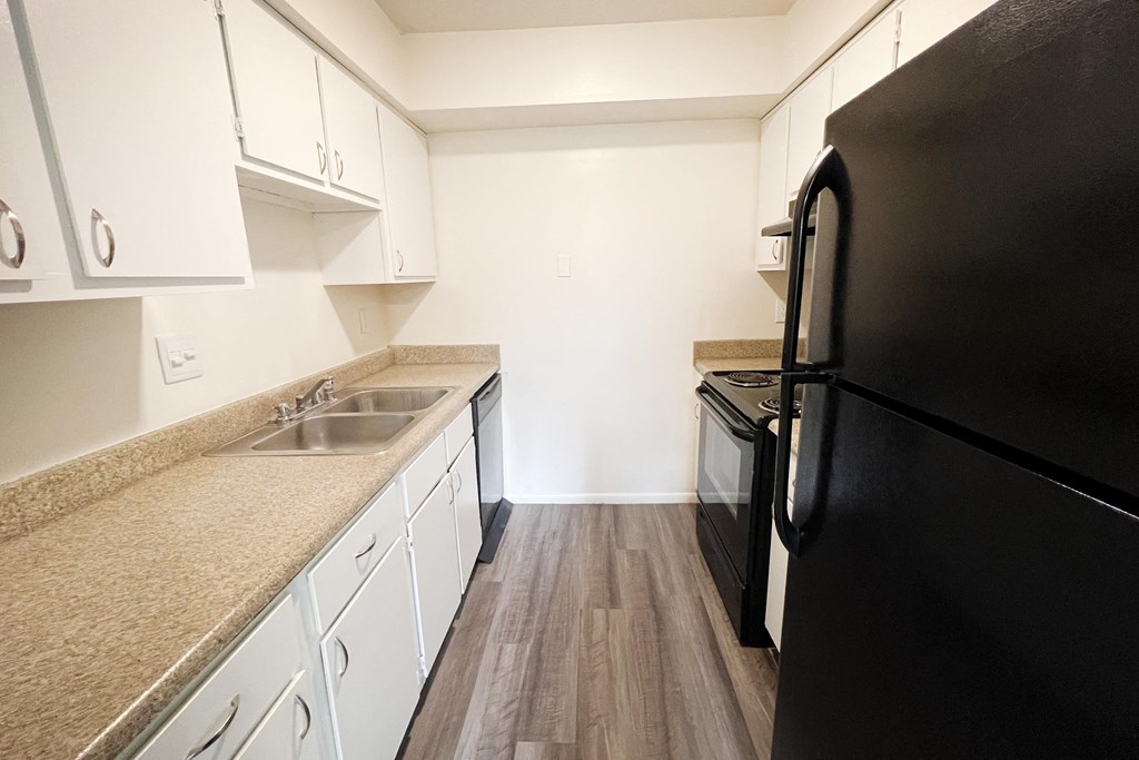 a kitchen with white cabinets and black appliances  at Hunter's Creek Apartments, Cincinnati, OH, 45242