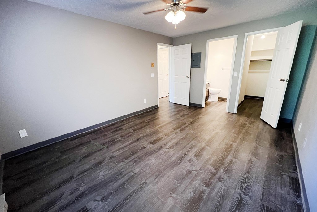 a bedroom with hardwood floors and a ceiling fan at Quail Meadow Apartments, Ohio