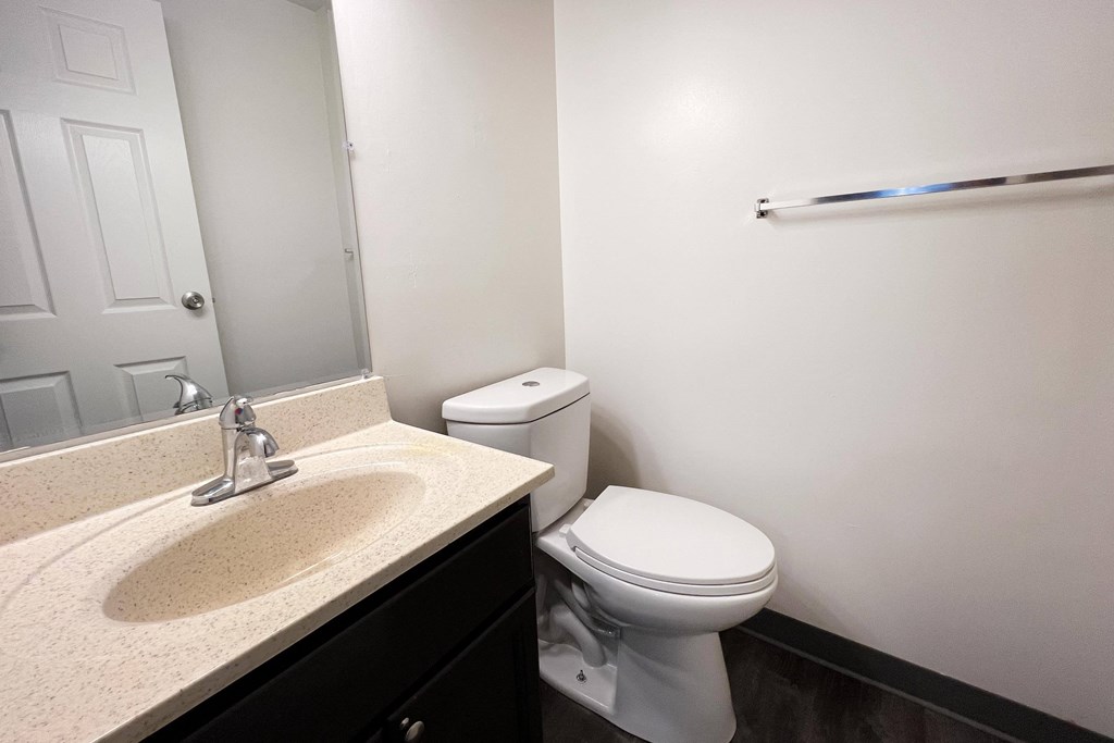 a bathroom with a sink toilet and mirror at Quail Meadow Apartments, Cincinnati, OH