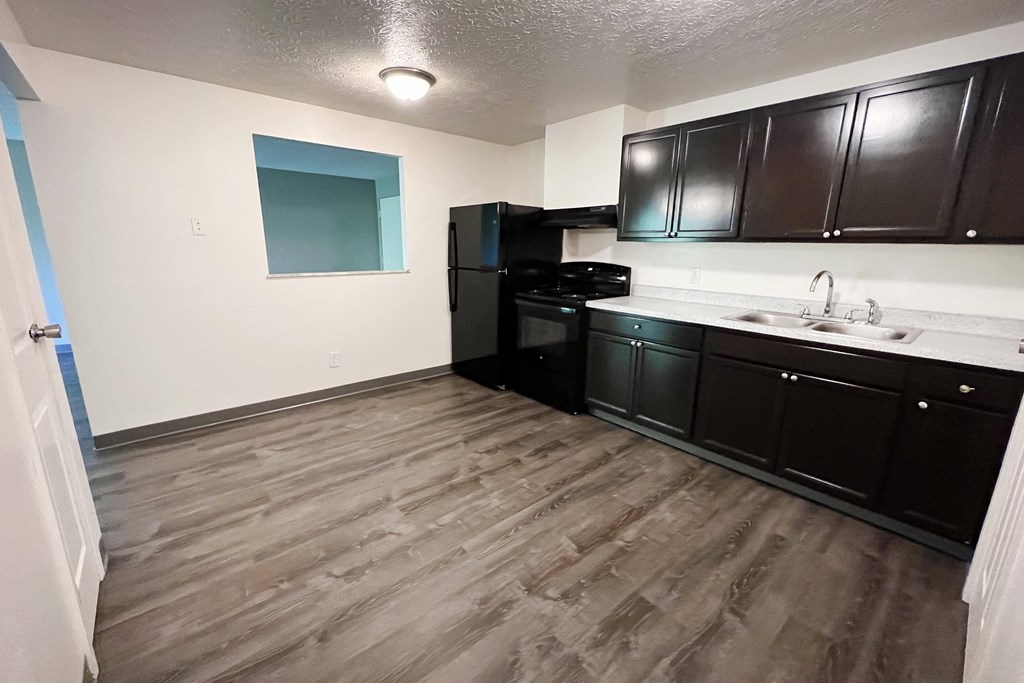 a kitchen with black cabinets and white countertops at Quail Meadow Apartments, Cincinnati, OH, 45240